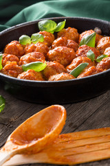 Traditional italian Meatballs served on a old wooden table. Meatballs served on a old wooden table with green napkin and spoon. Homemade delicious italian Meatballs on on a rustic table for dinner. it