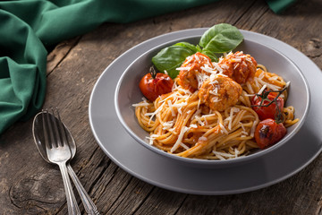 Traditional italian pasta served on a old wooden table. Pasta with Meatballs, parmesan cheese and herbs. Homemade delicious italian traditional pasta on on a rustic table for dinner. italian cuisine.