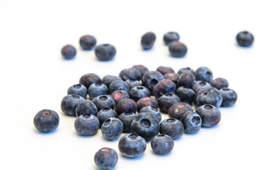 Still life photos of blueberries on a white background.