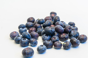Still life photos of blueberries on a white background.