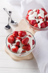 Strawberries with cream for two. Served on the table. Perfect for breakfast. Close-up shot. Free space for text.