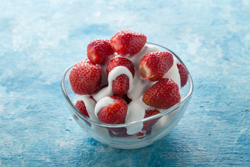 Strawberries with cream for two. Served on the table. Perfect for breakfast. Close-up shot. Free space for text.