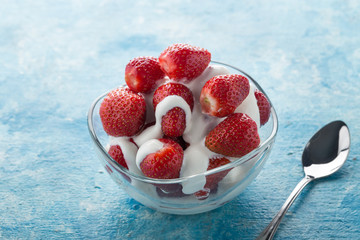 Strawberries with cream for two. Served on the table. Perfect for breakfast. Close-up shot. Free space for text.