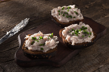 Bruschetta with lard. Bruschette with pate. Bruschette served on an old wooden table. Morning light. Morning breakfast. Close-up shot. Free space for text.