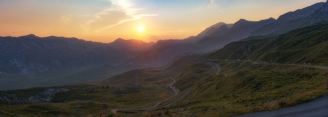 Winding road seen from Sedlo Pass in Durmitor National Park in Montenegro at sunset