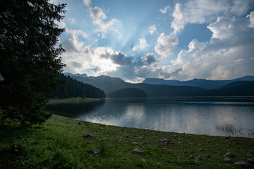 Black lake (Crno jezero) summer cloudy evening sunset landscape. Zabljak Municipality, Montenegro.