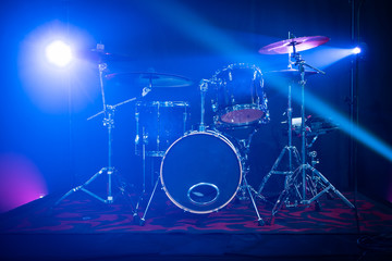 Fototapeta na wymiar Drum kit on a stage with Stage Lights around it. Professional musical instruments. 