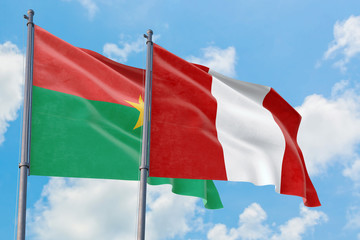 Peru and Burkina Faso flags waving in the wind against white cloudy blue sky together. Diplomacy concept, international relations.