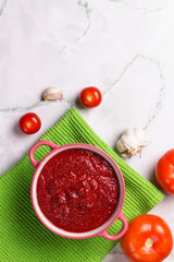 Tomato soup with parsley, onion and garlic on marble background. Comfortable food. Rustic style. Copy space. .