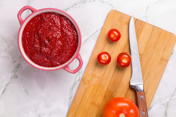 Tomato soup with parsley, onion and garlic on marble background. Comfortable food. Rustic style. Copy space. .