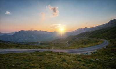 Winding road seen from Sedlo Pass in Durmitor National Park in Montenegro at sunset