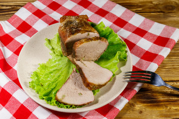Tasty baked pork with spices on a wooden table
