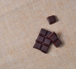 pieces of dark chocolate on sackcloth
