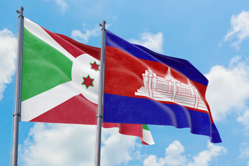 Cambodia and Burundi flags waving in the wind against white cloudy blue sky together. Diplomacy concept, international relations.