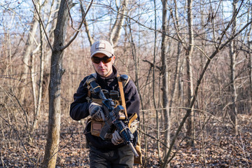 Fototapeta premium Male from private military company with rifle in the forest