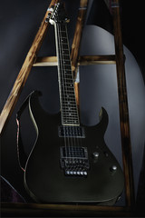 Obraz na płótnie Canvas art photo of an electric guitar on a stand, black background