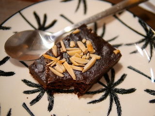 Brownie cake in a plate with a small spoon