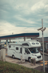 campervan fuels in gas station camping in the parking near the forest mobile home for an outdoor nomad lifestyle camper van caravan vehicle for van life holiday on camper van journey