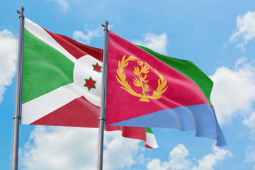Eritrea and Burundi flags waving in the wind against white cloudy blue sky together. Diplomacy concept, international relations.