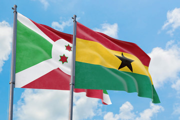 Ghana and Burundi flags waving in the wind against white cloudy blue sky together. Diplomacy concept, international relations.