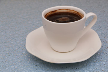 Close-up - a cup of coffee, a spoon in a cup.