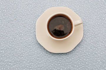 Close-up - a cup of coffee, a spoon in a cup.