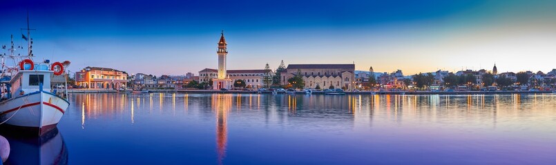 Obraz premium View on town hall and Saint Dionysios Church, Ionian Sea, Zakynthos island, Greece, Europe. Amazing sunset view. Zakynthos tower in the evening lights. The main harbor of the city. Incredibly sunrise.