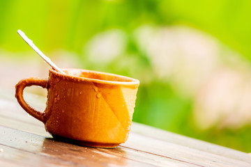 Wet coffee cup On a wooden floor