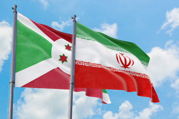 Iran and Burundi flags waving in the wind against white cloudy blue sky together. Diplomacy concept, international relations.