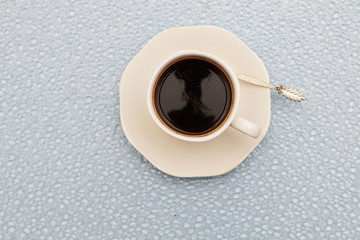 Close-up - a cup of coffee, a spoon in a cup.