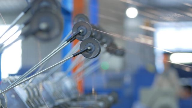 Production of copper stranded cable. Rotating shafts with fine copper thread.