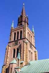 Fototapeta na wymiar Old church tower against a blue sky