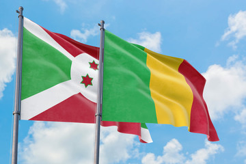 Mali and Burundi flags waving in the wind against white cloudy blue sky together. Diplomacy concept, international relations.