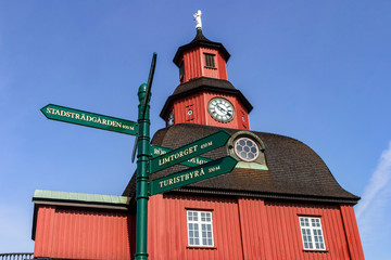 Obraz premium Beautiful wooden tower with a clock and signpost in Lidköping, Sweden