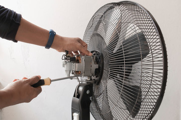 Close-up motor fan Repair and maintenance of home appliances for fixing the fan,  nut and wire copper roll of motor fan onbackground