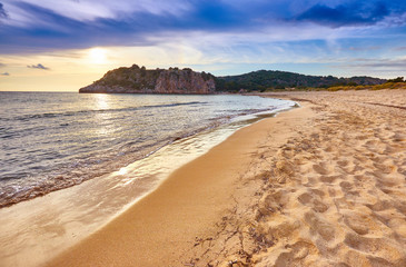 Amazing sunset view with multicolored clouds. Incredibly romantic sunrise on Voidokilia beach,...