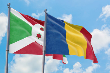 Fototapeta na wymiar Romania and Burundi flags waving in the wind against white cloudy blue sky together. Diplomacy concept, international relations.