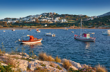 Obraz premium Fishing boats in the morning light. Sunrise on Nuevo Loca Beach. Traveling concept background. Palaia Fokaia location. Greece, Europe. Sunny morning seascape. Spring on the Greek coast Aegean sea