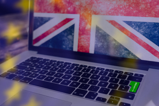 Green button on computer for brexit, union jack on the screen and the stars from the EU flag as transparent overlay - Powered by Adobe