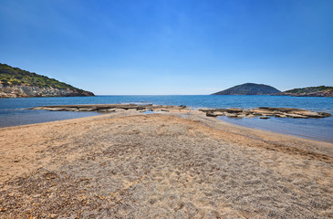 Sunrise on Nuevo Loca Beach. Traveling concept background. Palaia Fokaia, beginning of the beach season. Greece, Europe. Sunny morning seascape. Spring light on the Greek coast, Aegean sea