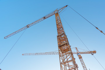 Construction site with high-rise construction cranes.