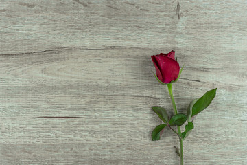 Fototapeta na wymiar Red rose flower on wood table background. Love, Romantic and Happy Valentines day Holiday concept