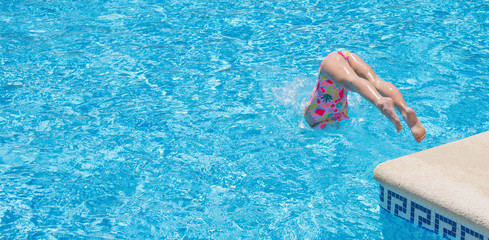 Pretty little girl in swimming pool, summer vacations.