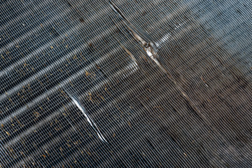 The surface of the car cooling radiator with damages by stones on a road