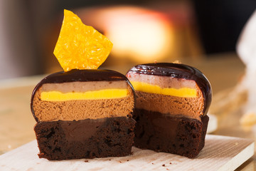 Half of french mousse portion cake covered with chocolate glaze