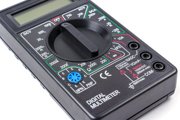 Digital multimeter in black plastic case close-up on a white background