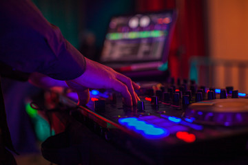 Dj mixing music in night club, close up