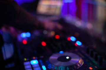 Obraz na płótnie Canvas Dj mixing music in night club, close up