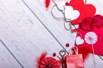 Wooden white background with red hearts and gifts. The concept of Valentine Day with empty copy space for text. Top view from above. Flat lay