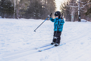 Happy little boy on a ski trip